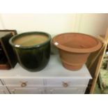 A green glazed garden pot together with a clay pot