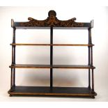 A set of Regency black and parcel gilt wall shelves, the three graduated tiers separated by turned