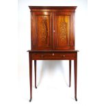 An Edwardian rosewood, boxwood strung and marquetry cabinet, the top with two blind panel doors