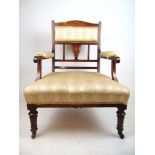 An Edwardian rosewood, boxwood strung and marquetry open arm chair upholstered in a patterned