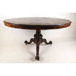 A late 19th century walnut breakfast table, the quarter veneered oval tilt top on a carved column