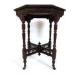 An Edwardian walnut occasional table, the octagonal top on turned legs joined by pierced galleried