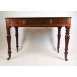 A 19th century mahogany side table, the top over three drawers on turned and reeded legs terminating