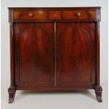 An early 19th century mahogany cabinet, the top over single drawer above two arch panel cupboard