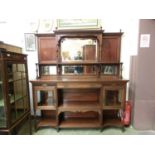 A late 19th century walnut sideboard by Gillows of Lancaster, the bevelled mirrored back over