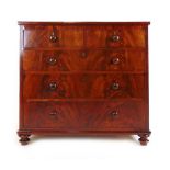 A 19th century flame mahogany chest of two short over three long drawers on turned feet, h. 105