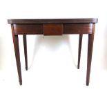 An early 19th century mahogany, boxwood strung and ebony banded tea table, the fold over top