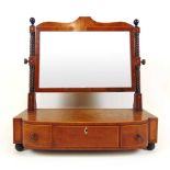 A Regency mahogany and boxwood strung toilet mirror, the plate supported on turned uprights