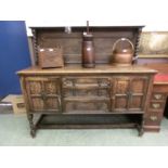 An early 20th century oak sideboard, the back with barley twist supports over the base with three