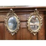 A pair of early 20th century gilt framed rococo mirrors