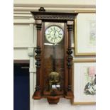 An early 20th century walnut cased drop dial wall clock