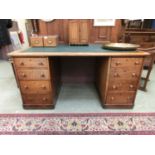 An early 20th century oak twin pedestal desk