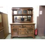 An early 20th century walnut possibly Scottish mirror back sideboard, the top with leaded glass