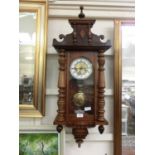 An early 20th century walnut cased drop dial wall clock