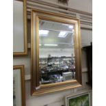 A modern gilt framed bevel glass mirror