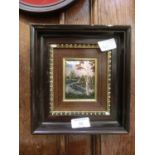 A framed Limoges plaque depicting river through countryside scene