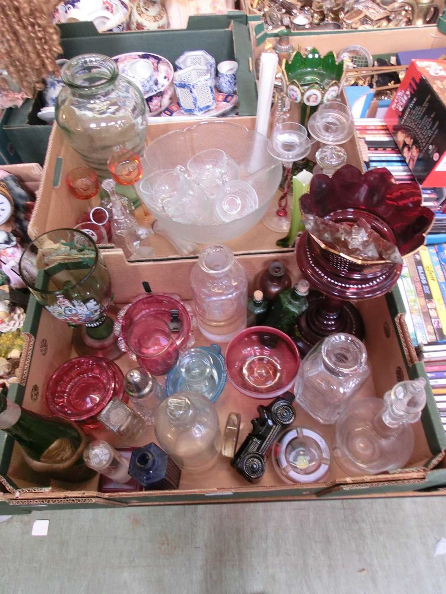 Two trays of assorted glassware to include punch bowl, decanters, etc