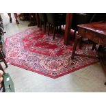 A red ground octagonal rug