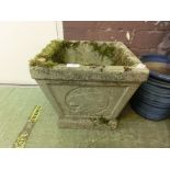 A weathered garden concrete planter together with a weathered concrete garden boot