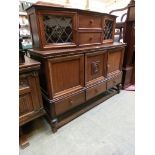 A mid-20th century court style sideboard having removable top having two drawers with leaded glass