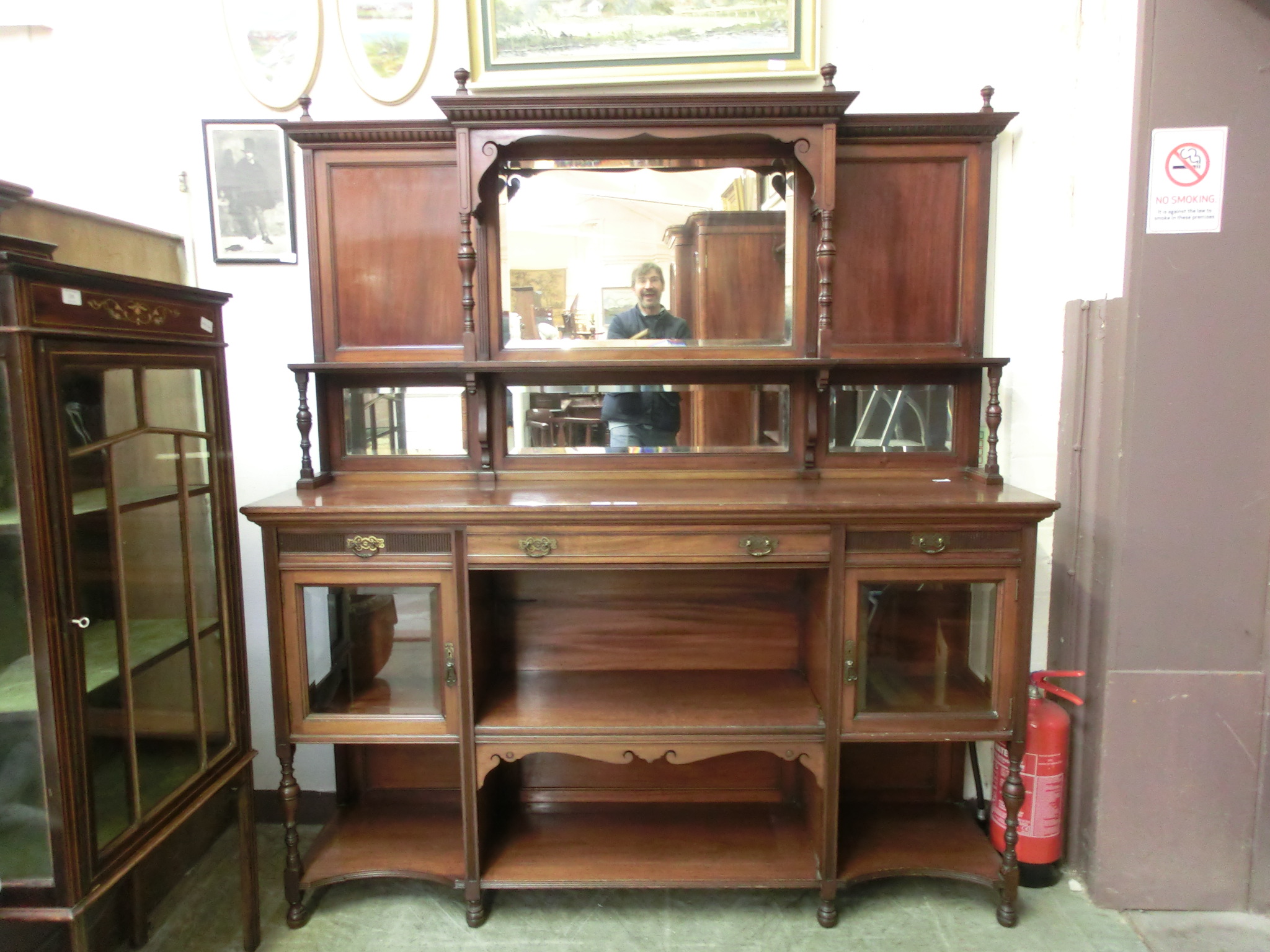 A late 19th century walnut sideboard by Gillows of Lancaster, the bevelled mirrored back over