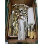 A tray containing an assortment of flatware, candlestick, trays, etc