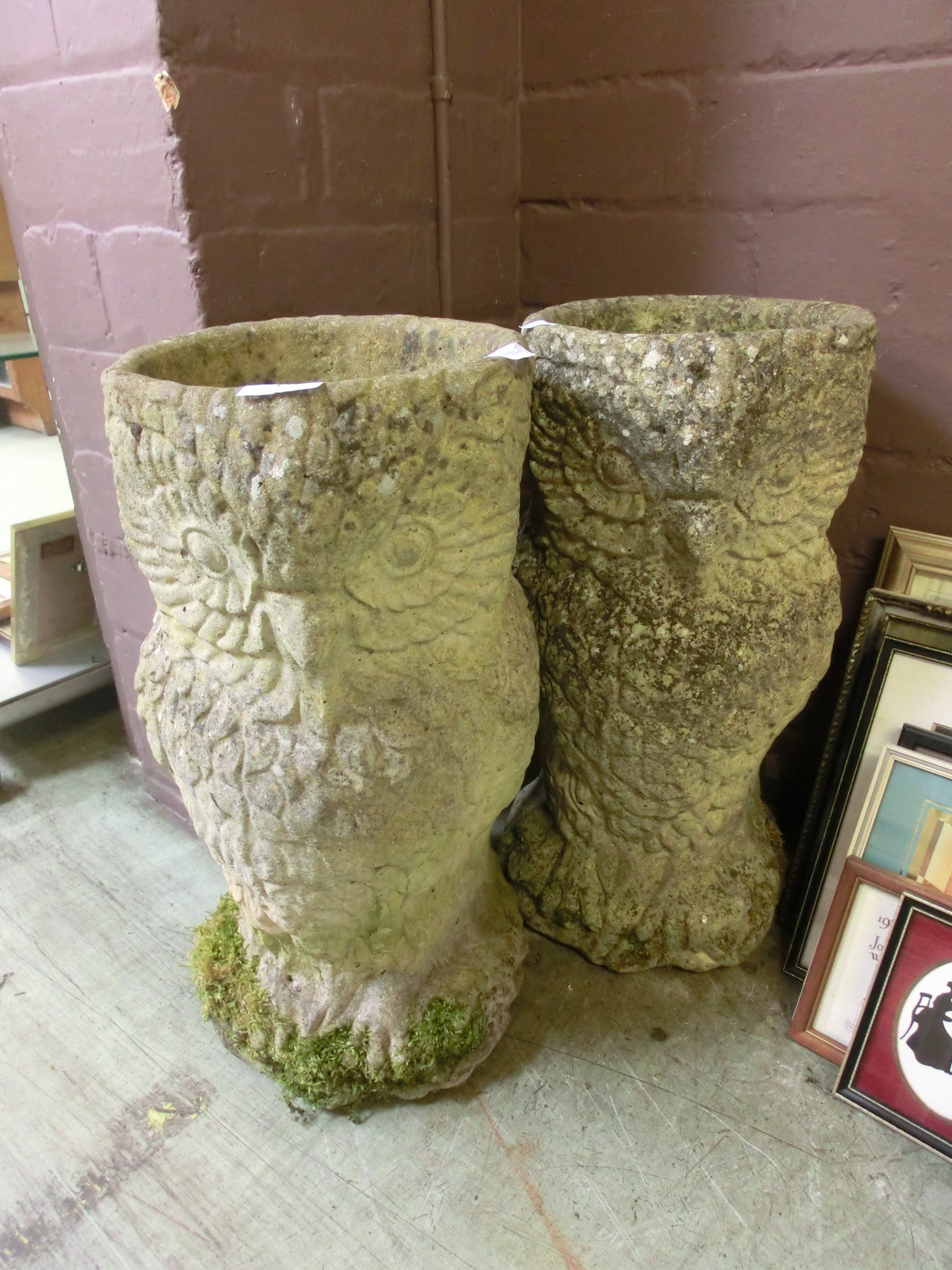 A pair of weathered planters in the form of owls