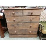 An early 20th century pine chest of two short over three long drawers