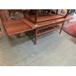 A mid-20th century design teak table having a slatted under tier together with pull out slide to
