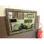 A modern gilt effect framed mirror