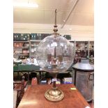 A brass table lamp with dome glass shade