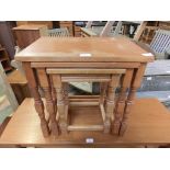 A nest of three oak occasional tables