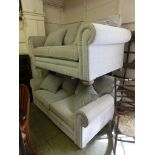 A pair of modern two seater settees upholstered in a light beige cut fabric