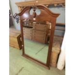 A reproduction swan necked wall mounted mirror