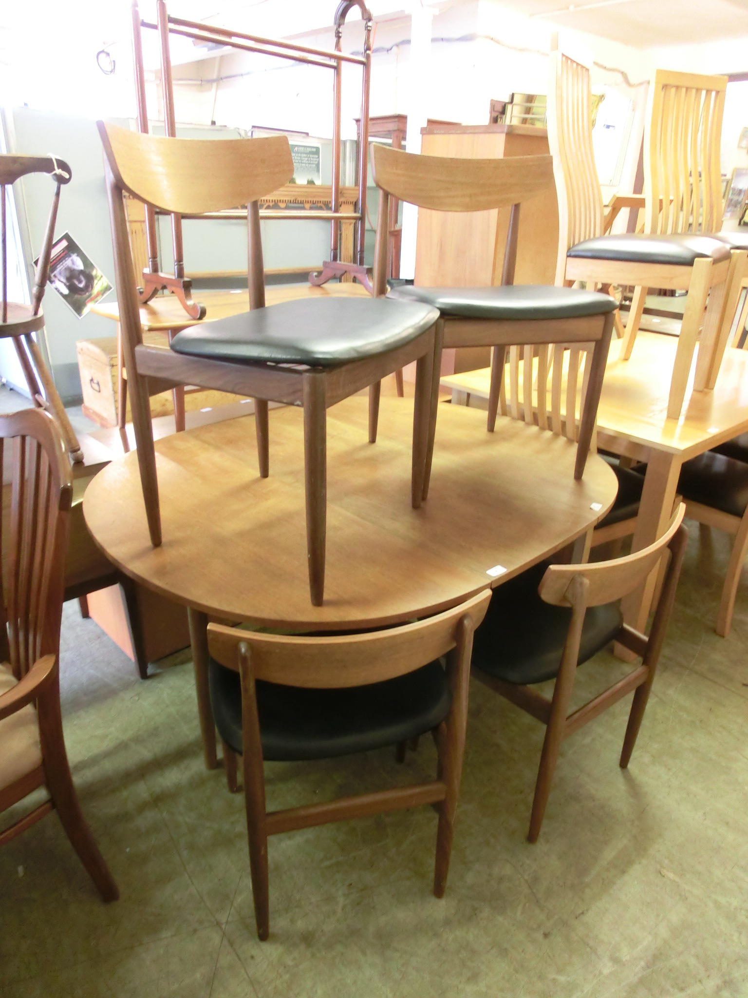 A mid-20th century design G-Plan drop leaf table together with a set of four matching chairs with