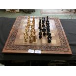 A chess board with an assortment of wooden chess pieces
