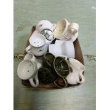 A carton containing ceramic shaving jugs, moulded figures of teddy bears, etc