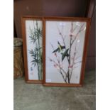 A pair of framed and glazed oriental prints on silk of birds on branches