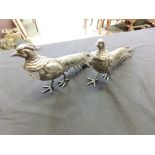 A pair of white metal pheasants