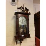 A reproduction stained pine drop dial wall clock