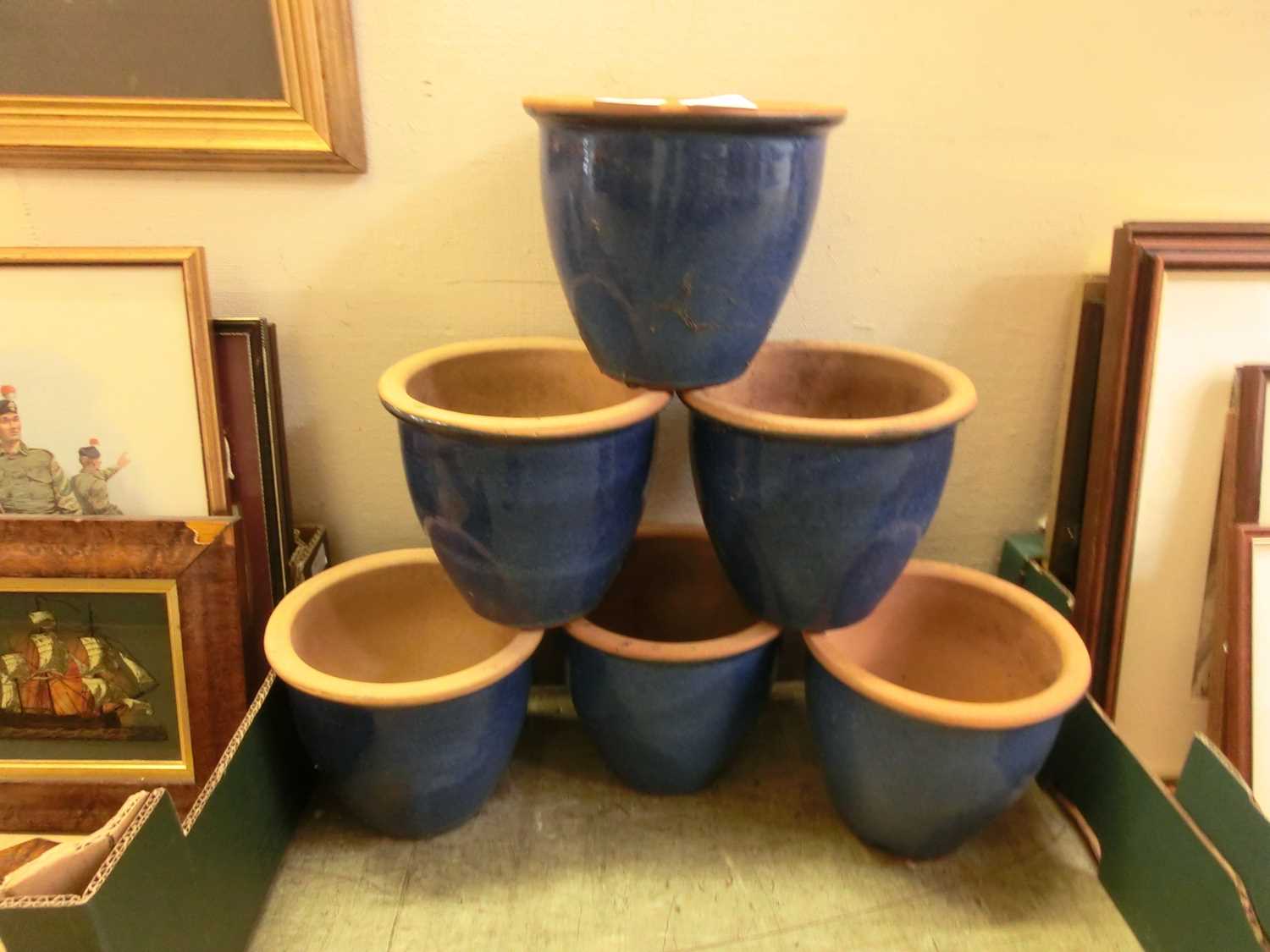 A set of six blue glazed garden pots