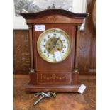 An Edwardian mahogany and inlaid mantle clock