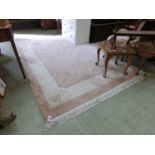 A Chinese style beige and cream ground rug