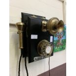 A wall mounted old style telephone with modern plug