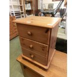 A modern pine three drawer bedside chest