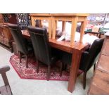 An eastern hardwood rectangular dining table together with a six faux leather upholstered chairs