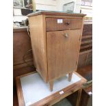 A mid-20th century bedside cabinet having single drawer above cupboard door