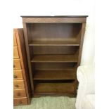 A mid-20th century oak veneered open bookcase