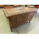 An Indian carved walnut blanket box on cabriole legs with part fitted interior