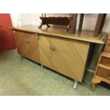 A late 20th century Oroko sideboard with three cupboard doors, chromed legs and handles